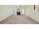 Bright living room with a fireplace, large windows, and neutral carpeting at 33 Bluestone Dr, Smithfield, NC 27577