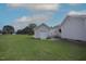 Spacious backyard featuring a storage shed, patio, and lush green lawn at 3409 Bennyfield Ct, Fuquay Varina, NC 27526