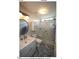Stylish bathroom features a glass-enclosed shower, marble floors, and modern fixtures at 3409 Bennyfield Ct, Fuquay Varina, NC 27526