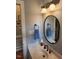Well-lit bathroom with marble sink and an oval mirror at 3409 Bennyfield Ct, Fuquay Varina, NC 27526