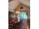 Traditional dining room with wood table, chandelier, and large windows overlooking the landscaped yard at 3409 Bennyfield Ct, Fuquay Varina, NC 27526