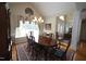 Elegant dining room with a chandelier, hardwood floors, and large window at 3409 Bennyfield Ct, Fuquay Varina, NC 27526