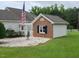 Home exterior featuring a detached structure, flagpole, and well-maintained lawn at 3409 Bennyfield Ct, Fuquay Varina, NC 27526