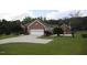 Charming brick home features a well-manicured lawn and attached two-car garage at 3409 Bennyfield Ct, Fuquay Varina, NC 27526