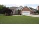 Beautiful brick house with a two-car garage and lush green lawn at 3409 Bennyfield Ct, Fuquay Varina, NC 27526