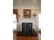 Close-up of a fireplace with a decorative screen, mantel, and stone hearth at 3409 Bennyfield Ct, Fuquay Varina, NC 27526