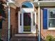Elegant front door with decorative glass, sidelights, and brick surround at 3409 Bennyfield Ct, Fuquay Varina, NC 27526