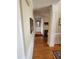 Inviting hallway with hardwood floors, wainscoting, and decorative mirror leading to other rooms in the house at 3409 Bennyfield Ct, Fuquay Varina, NC 27526