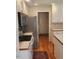 Kitchen with white cabinets, tile countertops, stainless steel refrigerator, and modern appliances at 3409 Bennyfield Ct, Fuquay Varina, NC 27526