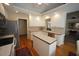 Modern kitchen with white cabinets, stainless steel appliances, and a functional island at 3409 Bennyfield Ct, Fuquay Varina, NC 27526