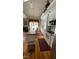 Bright kitchen featuring white cabinets, stainless steel appliances, and a cozy dining area at 3409 Bennyfield Ct, Fuquay Varina, NC 27526