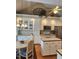 Open kitchen with white cabinetry, island, stainless appliances, and a breakfast nook at 3409 Bennyfield Ct, Fuquay Varina, NC 27526