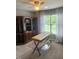 Office featuring a built-in bookcase, natural light, and neutral walls at 3409 Bennyfield Ct, Fuquay Varina, NC 27526