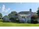 Manicured backyard featuring white patio and detached garage, perfect for relaxation at 3409 Bennyfield Ct, Fuquay Varina, NC 27526