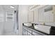 Bright bathroom with double sinks, gold fixtures, granite counters, and large mirror reflecting shower at 3537 Sweetgum Rd, Gibsonville, NC 27249