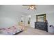 Bedroom with wood-look flooring, ceiling fan, and closet space, along with a dresser and decor at 3537 Sweetgum Rd, Gibsonville, NC 27249