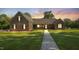 Beautiful brick home featuring a well-manicured lawn, a cozy front porch, and a walkway to the entrance at 3537 Sweetgum Rd, Gibsonville, NC 27249
