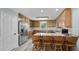 Bright kitchen features wooden cabinets, modern appliances, and a breakfast bar with seating at 3537 Sweetgum Rd, Gibsonville, NC 27249