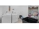 Clean laundry room with washer, dryer, shelving for storage, and a utility sink at 3537 Sweetgum Rd, Gibsonville, NC 27249