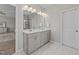 Modern bathroom features a double sink vanity with white marble floors, cabinets, and bright lighting at 3613 Cross Timber Ln, Raleigh, NC 27603