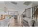 Open-concept living room with hardwood floors, staircase and abundant natural light creating an airy atmosphere at 3613 Cross Timber Ln, Raleigh, NC 27603