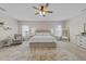 Bright main bedroom features a ceiling fan, neutral tones, carpet floors and a large decorative rug at 3613 Cross Timber Ln, Raleigh, NC 27603