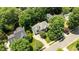 Aerial view featuring a landscaped property, mature trees and a circular driveway at 3720 Bridgeton Park Dr, Raleigh, NC 27612