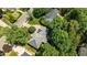 Aerial view highlighting a well-maintained home surrounded by lush greenery and mature trees at 3720 Bridgeton Park Dr, Raleigh, NC 27612