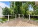 Spacious back deck with white railing and wooded view provides ideal outdoor living space at 3720 Bridgeton Park Dr, Raleigh, NC 27612