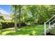Grassy backyard with mature trees offers plenty of space for activities and landscaping at 3720 Bridgeton Park Dr, Raleigh, NC 27612