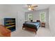 Simple bedroom with built in desk, blue bookshelf, and plenty of natural light from the windows at 3720 Bridgeton Park Dr, Raleigh, NC 27612