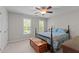 Traditional bedroom featuring a wood bed frame, two windows, and a decorative blanket chest at 3720 Bridgeton Park Dr, Raleigh, NC 27612