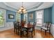 Elegant dining room with a wooden table, chandelier, and lots of natural light at 3720 Bridgeton Park Dr, Raleigh, NC 27612