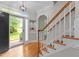Open entryway with hardwood floors, a staircase, and views into other rooms of the home at 3720 Bridgeton Park Dr, Raleigh, NC 27612