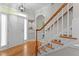 Inviting foyer featuring hardwood floors, a staircase, and an open doorway at 3720 Bridgeton Park Dr, Raleigh, NC 27612