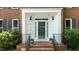 Close-up of the home's front door and covered porch with brick steps at 3720 Bridgeton Park Dr, Raleigh, NC 27612