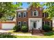Charming brick home with a well-manicured lawn, gray shutters and a welcoming front entrance at 3720 Bridgeton Park Dr, Raleigh, NC 27612
