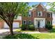 Charming brick home with a well-manicured lawn, front-facing garage, and detailed window shutters at 3720 Bridgeton Park Dr, Raleigh, NC 27612