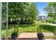 View of the front yard, showing a long driveway with the home and greenery in the background at 3720 Bridgeton Park Dr, Raleigh, NC 27612