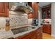 A kitchen is shown with granite countertops, stainless steel appliances and wooden cabinets at 3720 Bridgeton Park Dr, Raleigh, NC 27612