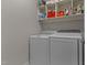 Convenient laundry area equipped with a washer, dryer, and shelving for storage at 3720 Bridgeton Park Dr, Raleigh, NC 27612