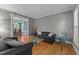 Comfortable living room with hardwood floors, neutral walls, and a view of the dining area at 3720 Bridgeton Park Dr, Raleigh, NC 27612