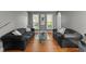 Spacious living room featuring hardwood floors, modern decor, and plenty of natural light at 3720 Bridgeton Park Dr, Raleigh, NC 27612