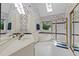 Bright main bathroom with a double vanity, garden tub, separate shower and natural light from a skylight at 3720 Bridgeton Park Dr, Raleigh, NC 27612