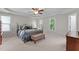 Spacious main bedroom with tray ceiling, fan, and large windows for natural light and outside views at 3720 Bridgeton Park Dr, Raleigh, NC 27612