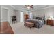 Large main bedroom featuring a tray ceiling, ceiling fan, dresser, windows and an ensuite entrance at 3720 Bridgeton Park Dr, Raleigh, NC 27612