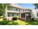 Rear exterior showing the home's design, screened porch and landscaped yard at 3720 Bridgeton Park Dr, Raleigh, NC 27612