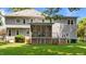 Rear exterior showcasing screened porch, wood siding and a large well maintained yard at 3720 Bridgeton Park Dr, Raleigh, NC 27612
