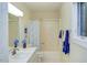 Well-maintained bathroom featuring a shower-tub combo, vanity, and ample natural light from a window at 3833 Hidden Branches Dr, Raleigh, NC 27613