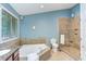 The blue bathroom has a garden tub, a shower, a toilet, and natural light at 3833 Hidden Branches Dr, Raleigh, NC 27613
